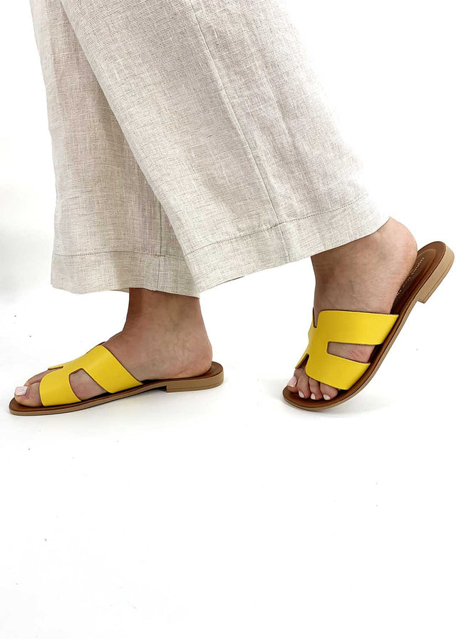 Elegant yellow H slippers for women in natural leather